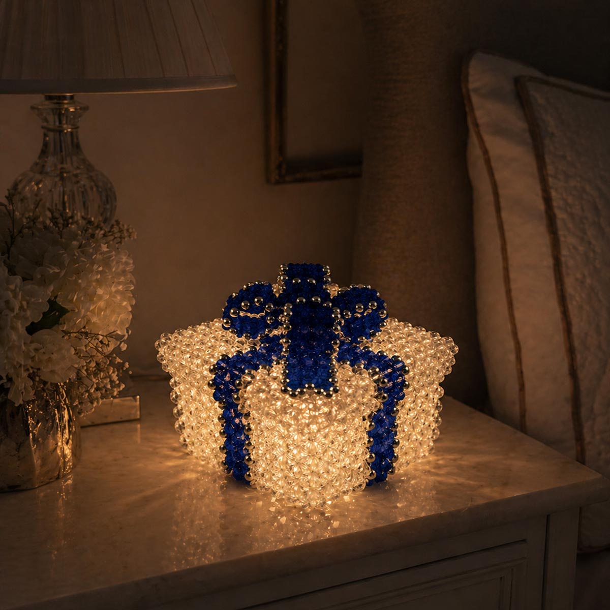 Crystal Beaded Box with Dark Sapphire Beaded Bow Glowing on a Nightstand
