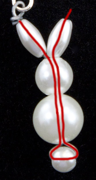 Inserting the wire into the earrings.