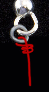 Inserting the wire into the earrings.
